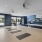 Yoga and spin studio with four yoga mats set up with yoga fitness class on tv