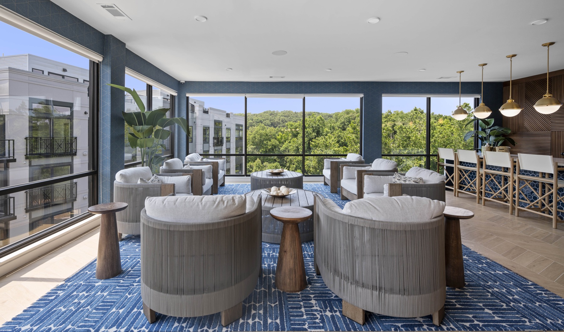 Find your perfect fit at Riverside Wilton Sky lounge with row of plush seating, coffee tables, side tables, and panoramic windows overlooking the River