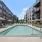 The pool area at Riverside Wilton Apartments in Wilton, CT, featuring beach chairs and umbrellas with tables.