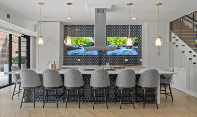 Take advantage of all Riverside Wilton has to offer Clubhouse kitchen with an island, stools, and two tv's