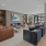 Resident lounge at Riverside Wilton Apartments in Wilton, CT, featuring wood grain flooring and cushioned seating.