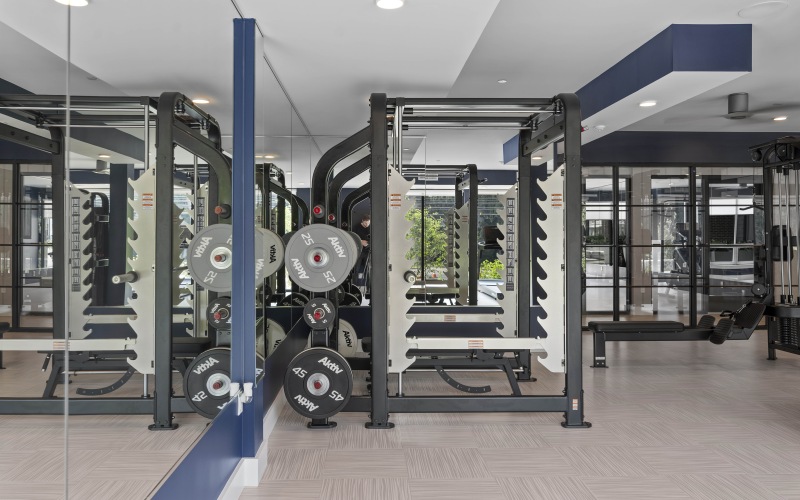 a gym with exercise equipment wall mirrors