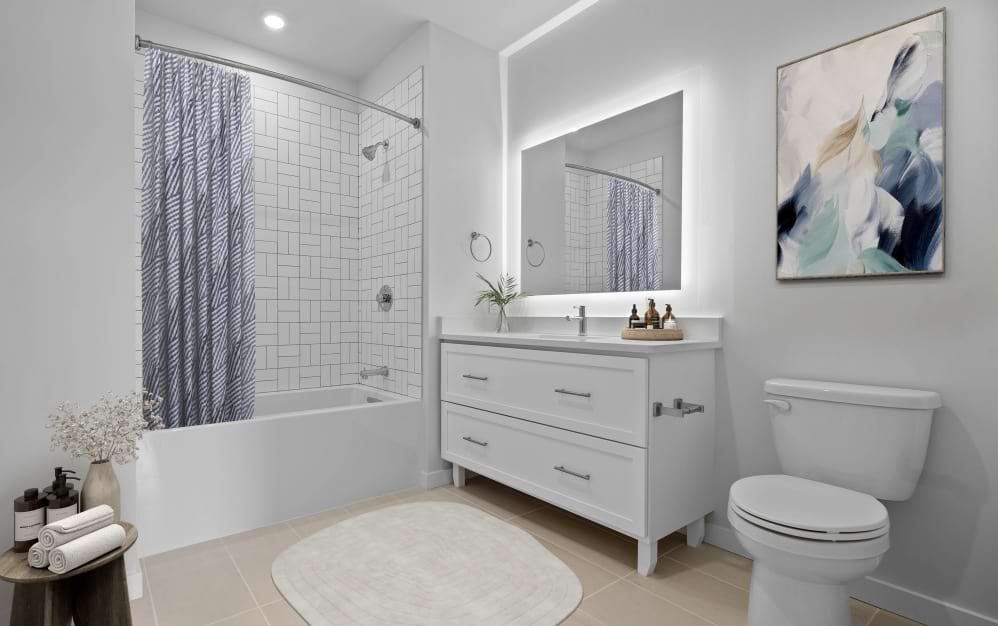 Modern bathroom in a Wilton CT spacious apartment with double vanity sinks and contemporary bath tile