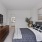 Furnished bedroom with hallway leading to bathroom and closet