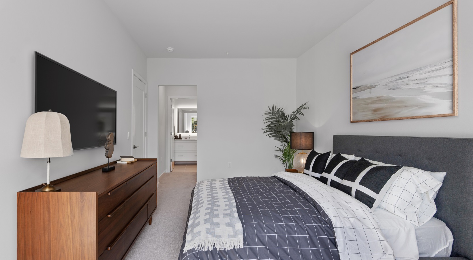 Spacious Bedrooms Furnished bedroom with hallway leading to bathroom and closet