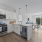 Model kitchen at Riverside Wilton Apartments in Wilton, CT, featuring wood grain flooring and white cabinetry.