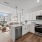 Model kitchen at Riverside Wilton Apartments in Wilton, CT, featuring wood grain flooring and white cabinetry.