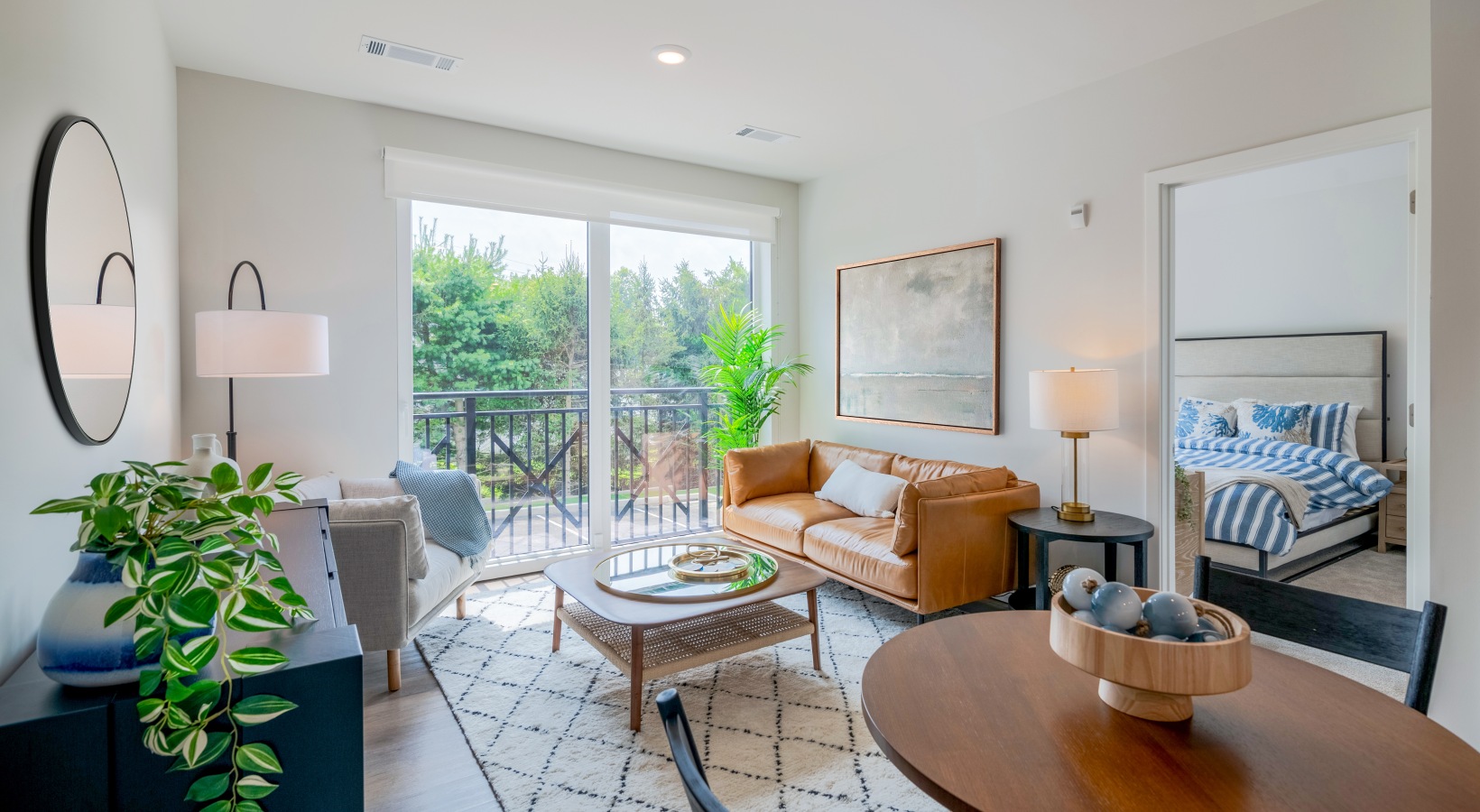 Exceptional natural light  Living room with couch, chair, coffee table, Juliette balcony, and eat in dining table set for two
