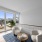 Stairs leading to second story loft area, staged with chairs, and work from home desk, leasing to furnished balcony