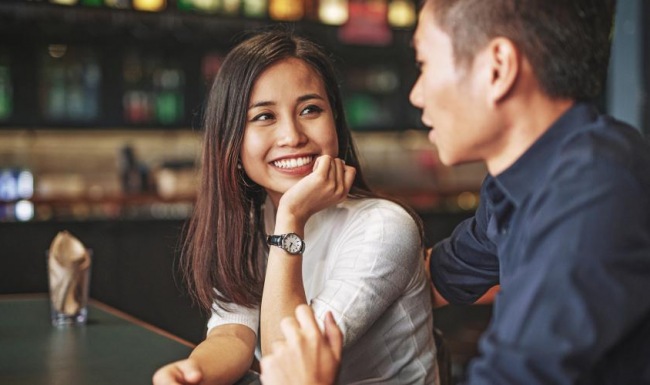 Bustling community with plenty of dining choices a man and a woman sit at a bar and talk